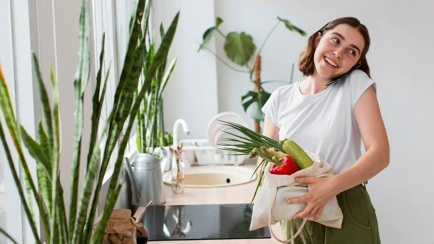 Front-facing view of a young woman holding bio vegetables.