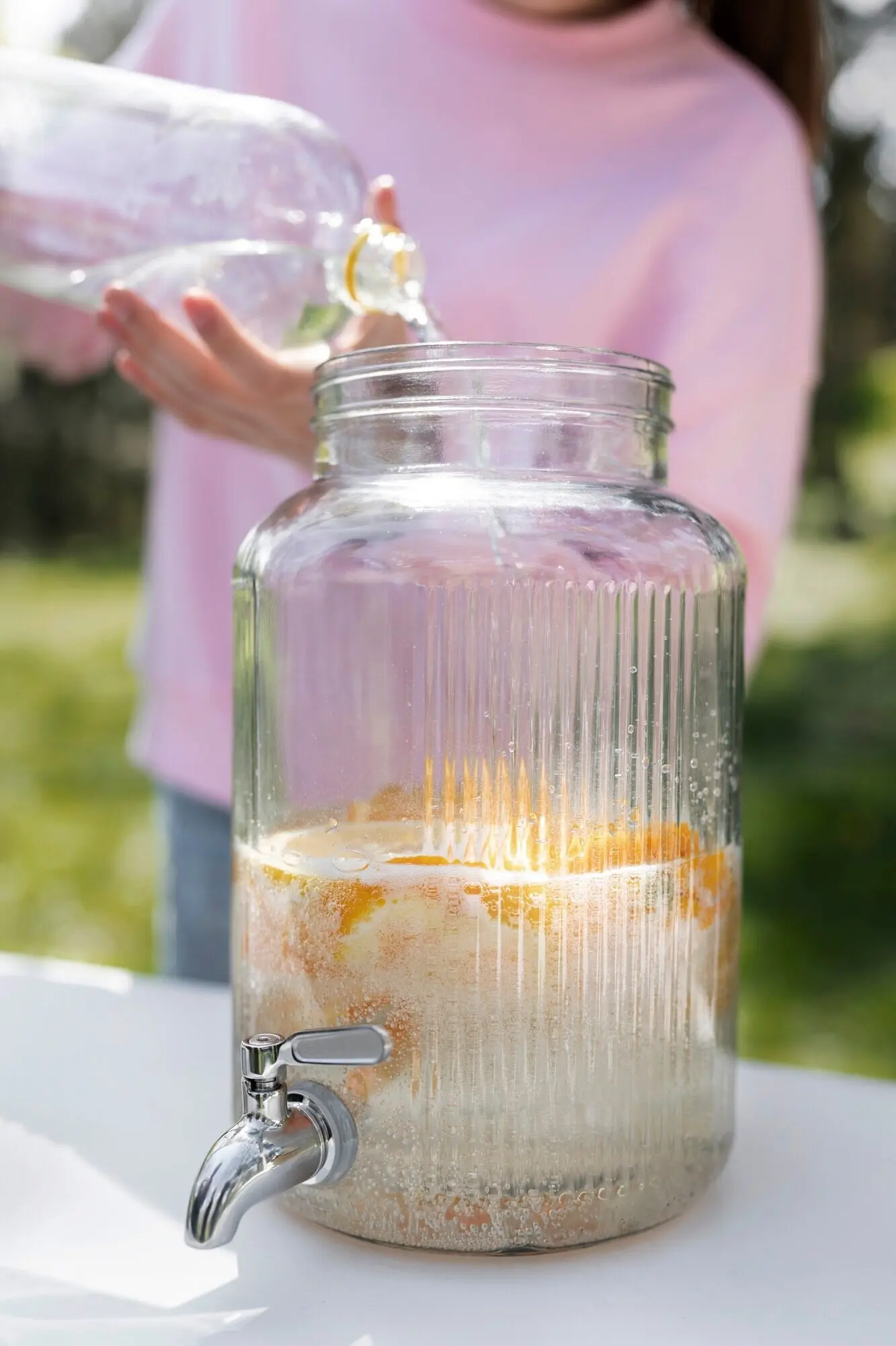 A girl making fresh lemonade, seen from the front.
