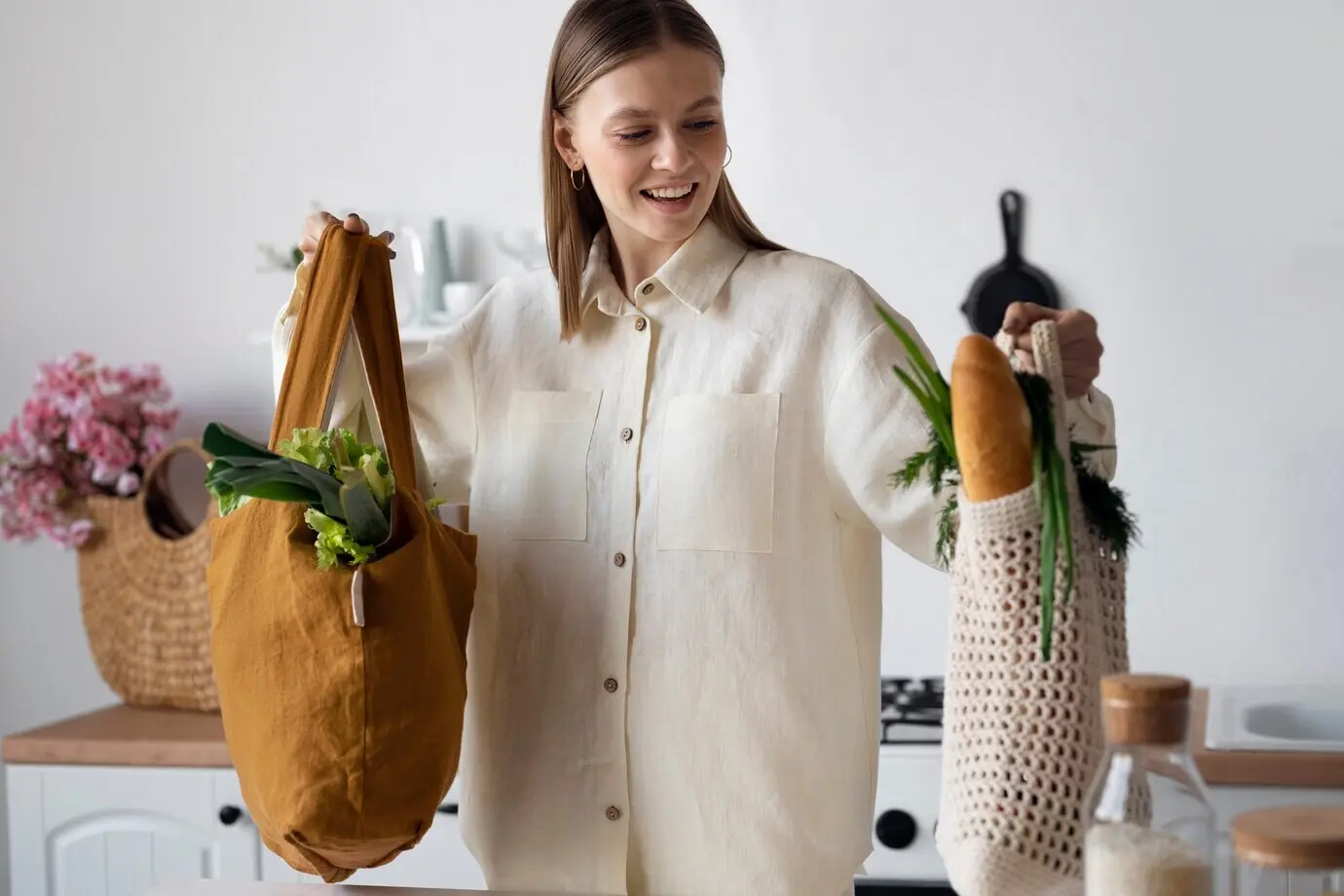 Medium shot of a smiling woman with tote bags.