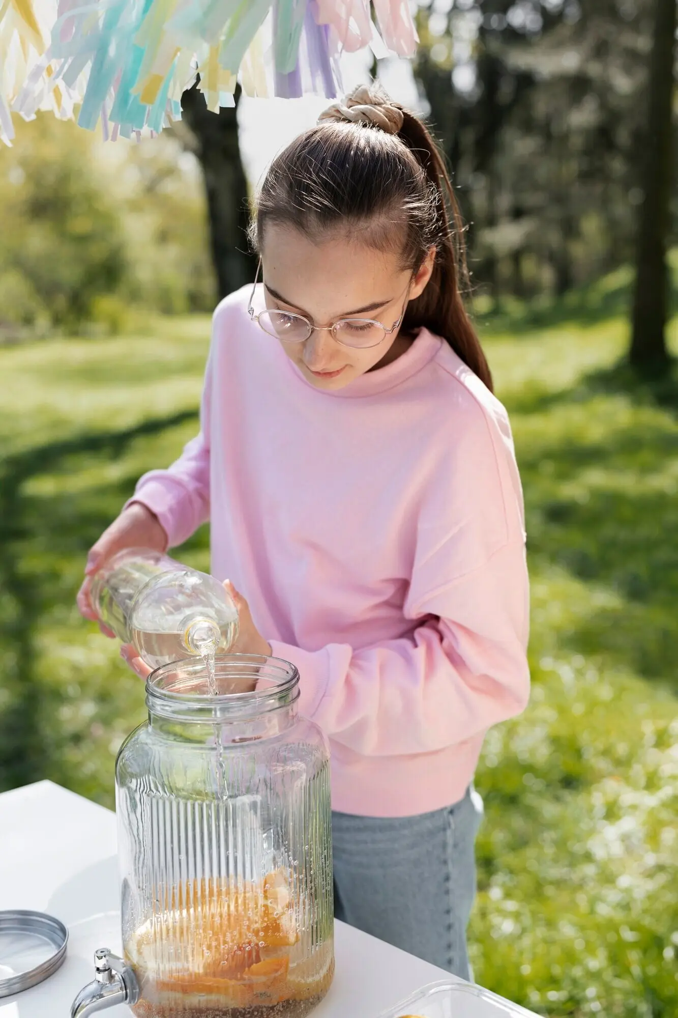 Overhead shot of a girl preparing fresh lemonade.